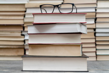Glasses on the background of books. Symbol of knowledge, science, study, wisdom.