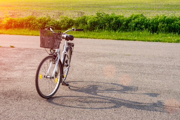 Silhouette of a bike in the forest at sunset. Bicycle and ecology lifestyle concept.