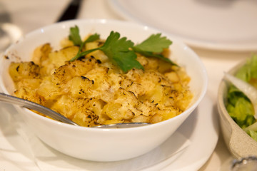 Potato stew with parsley on bowl