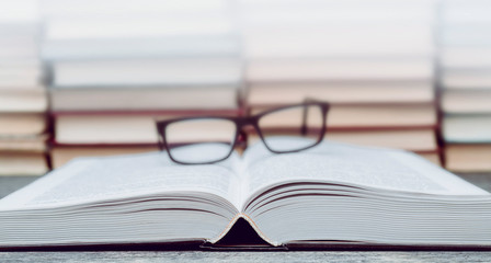 Glasses on the background of books. Symbol of knowledge, science, study, wisdom.