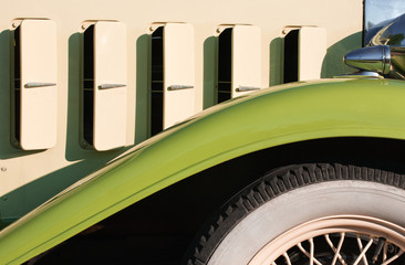 Antique car front fender, wheel and body detail.