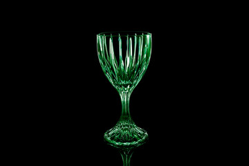 Green wine glass over black isolated background with reflection