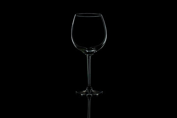Wine glass on a black isolated background with reflection