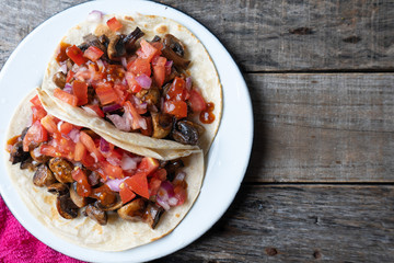 Vegan and vegetarian mexican mushrooms tacos with sauce and lime