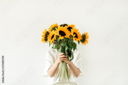 Young Pretty Woman In White Dress Hold Sunflowers Bouquet On White Background Florist Minimal Concept Wall Mural Floral Deco