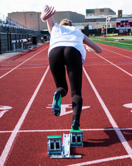 Female sprinter coming out of the blocks