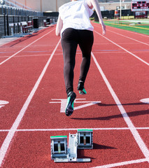 Sprinter racing down the track from behind the blocks