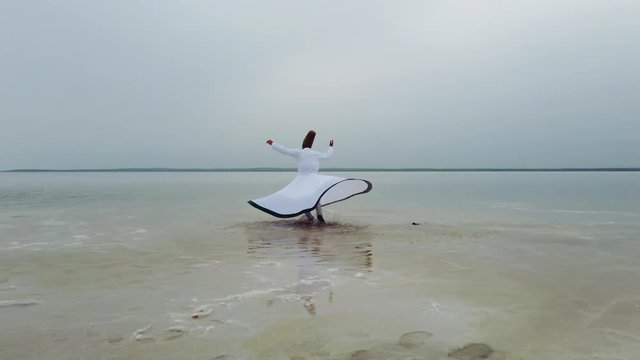 sunset and whirling at the sea, sufi. sufi whirling (Turkish: Semazen) is a form of Sama or physically active meditation which originated among Sufis. 4k