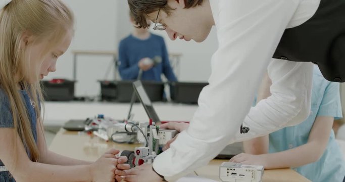 Curious kids working on a functional programable robot during robotics class at school. 4K UHD 60 FPS SLOW MOTION