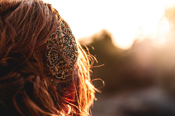 Portrait of pretty woman redhead with beautiful hairstyle decorated by gold shiny hair accessory