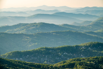 Fototapeta premium Layers of mountains in the haze during sunset. View from Mount Akhun, Sochi, Russia.