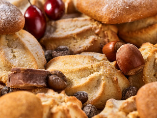 Oatmeal Cookies and sand chocolate cake with nut on wooden table in farm style close up.