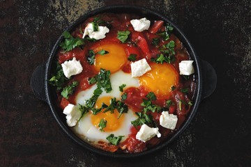 Shakshuka in a cast iron skillet. Flat Lay.