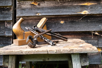 Antique hand tools plane pincers and drills. Old brown boards. Copy space