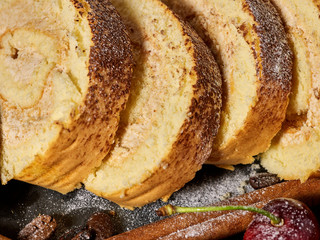 Slice rolled biscuit cake with cream for breakfast dessert close up. Perfect product.