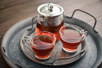 Two glass cup of tea with glass teapot