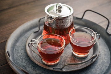 Two glass cup of tea with teapot