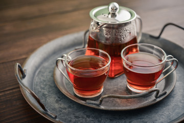 Two glass cup of tea with teapot