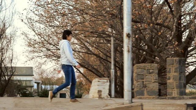 Chinese woman walking across bridge