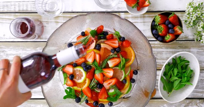 Overhead of sangria making with fresh fruit and mint