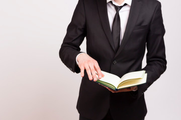  Man in suit with a notebook in hand