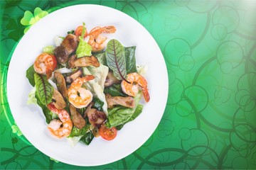 Green salad with shrimps on background