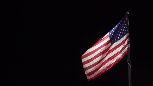 USA flag at black background at night