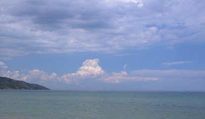  large white clouds against the sea