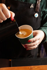 Heart shaped latte art on a cup of cappuccino