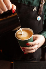 Heart shaped latte art on a cup of cappuccino
