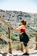 Naklejka premium Happy young woman hiker watching the landscape
