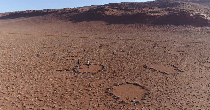 Aerial view of a tourist and guide exploring the famous fairy circles in the NamibRand Nature Reserve