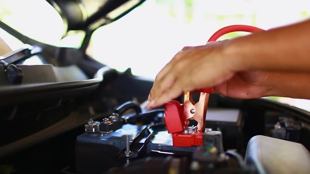 cable connection procedure car battery. step of charging car with electricity trough cables. first connect anode then follow connect negative connector battery. 