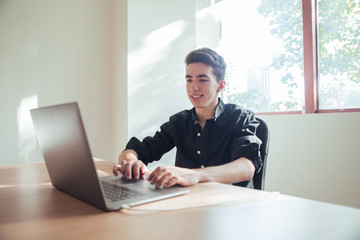 Portrait of boy working with dark shirt in office