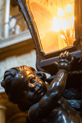 cherub holding a lamp