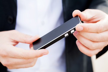 Man holding mini adapter for laptops and flash memory
