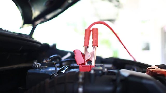 cable connection procedure car battery. step of charging car with electricity trough cables. first connect anode then follow connect negative connector battery. 