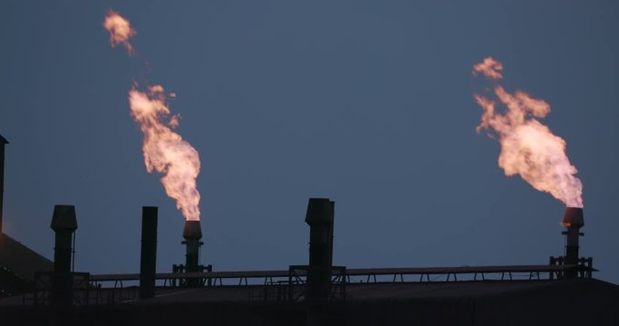 Polluting mine flare stack at sunset