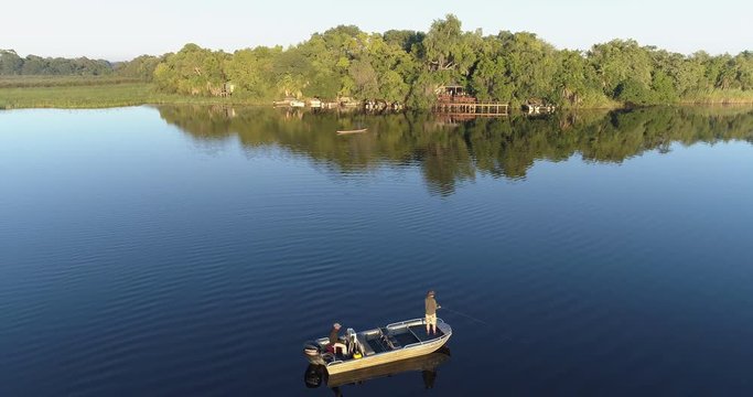 Aerial view of Fisherman fly fishing from a boat on the waterways of the Okavango Delta 