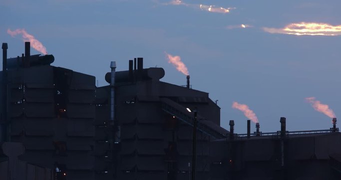 Polluting mine flare stack at sunset