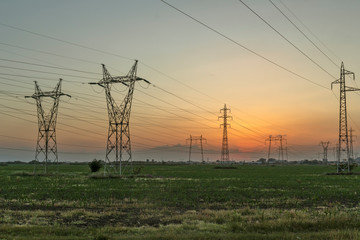 Amazing Sunset view over High-voltage power lines in the land around city of Plovdiv, Bulgaria