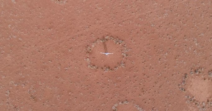 360 aerial view of a tourist exploring the famous fairy circles in the NamibRand Nature Reserve
