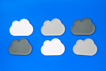 cloud computing concept with clouds on blue background top view