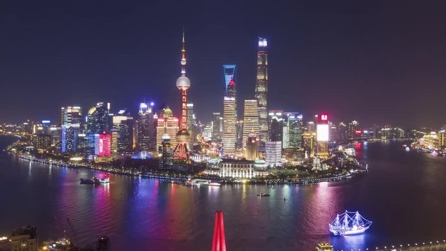 Shanghai City at Night. Urban Lujiazui District, Huangpu River and Waibaidu Bridge. China. Aerial Hyper Lapse, Time Lapse. Drone is Flying Forward and Upward