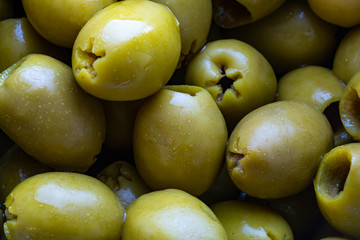 macro photo of pickled green oviles, cllose up food image