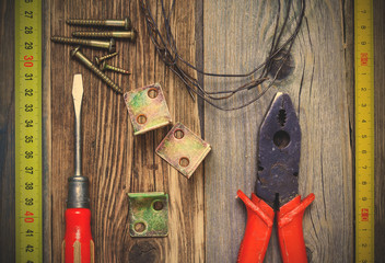 Vintage screwdriver, old pliers, screws, wire, angles