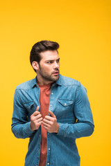 scared handsome man looking away Isolated On yellow