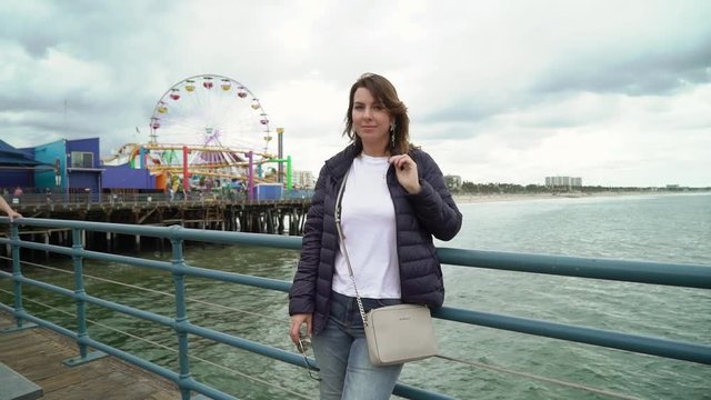 Young woman walking at Santa Monica pier in LA