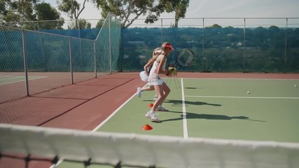 Girls doing warm up drills on tennis court
