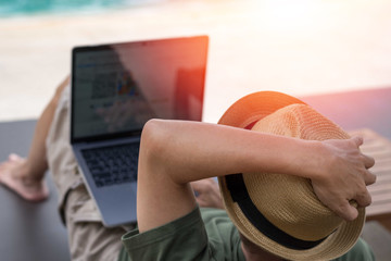Easy relax business man lifestyle with computer in hotel resort sitting hands behind head for happy businessman people with work life balance. Simplify Your Life Week. International happiness day.